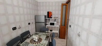 a room with a table and chairs and a refrigerator at Malagrino House in Rome