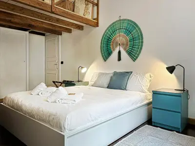 a bedroom with a large white bed with a blue dresser at Domus Trevis in Rome