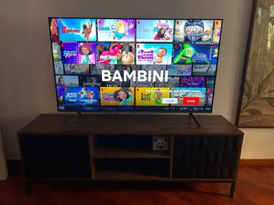 a flat screen tv sitting on top of a wooden stand at Holiday Rome Apartment in Rome