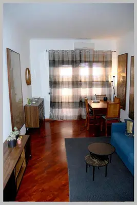 a living room with a blue couch and a table at Holiday Rome Apartment in Rome