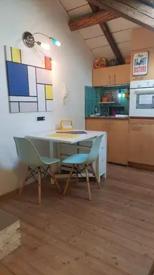 a kitchen with a table and chairs in a room at Loft at Ponte Milvio in Rome