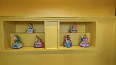 a shelf with a bunch of toy figurines on it at Loft at Ponte Milvio in Rome