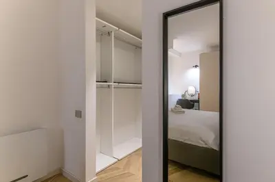 a mirror in a bedroom next to a bed at Trastevere Luxury Apartment in Rome