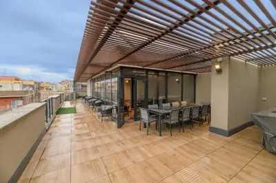 a balcony with tables and chairs on a building at Trastevere Luxury Apartment in Rome