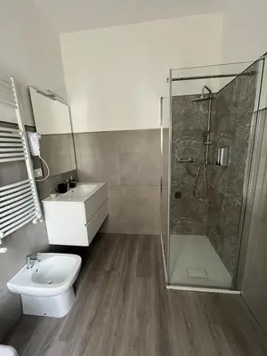 a bathroom with a shower and a toilet and a sink at Tiburtina Urban Rooms in Rome