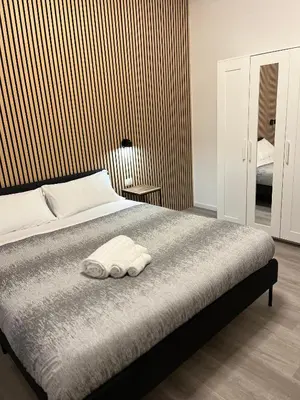 a bedroom with a bed with two towels on it at Tiburtina Urban Rooms in Rome