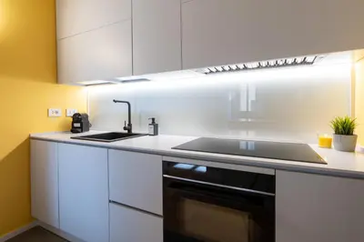 a kitchen with white cabinets and a sink at Sotto al letto del Papa - Borgo Pio - Vaticano in Rome