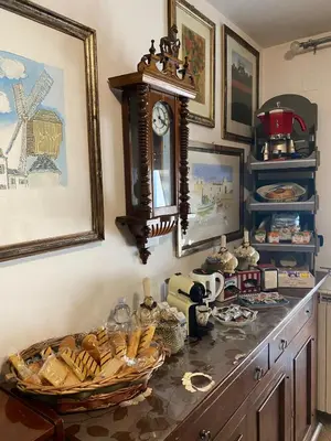 a table with a clock and a basket of bread at A casa di Simone in Rome