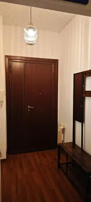a room with a large wooden door and a table at San Peter's Gates in Rome