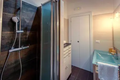 a bathroom with a shower and a blue sink at Aradam Luxury Heritage in Rome