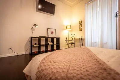 a bedroom with a bed and a table with a lamp at Aradam Luxury Heritage in Rome