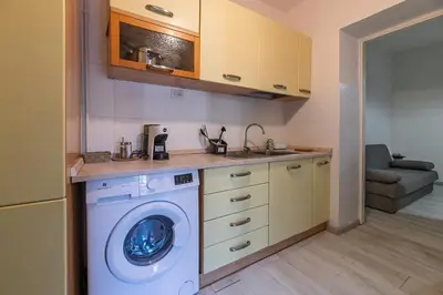 a kitchen with a washing machine and a sink at Delightful Tourist Apartment in Rome