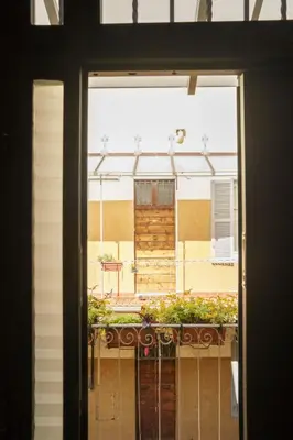 a window with a view of a balcony with a building at Casa Mau - Vacation Vibes in Rome