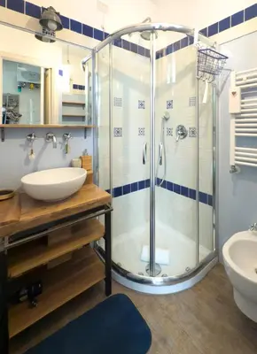 a bathroom with a glass shower and a sink at Casa Mau - Vacation Vibes in Rome