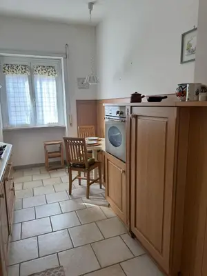 a kitchen with a stove and a table and a chair at Attico Balduina in Rome