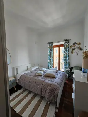 a bedroom with a bed and a large window at Obelisco Rhome in Rome