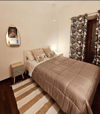 a bedroom with a bed and a mirror and a window at Obelisco Rhome in Rome