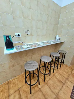 a row of stools sitting on a counter in a room at Costantino Imperatore Apt in Rome