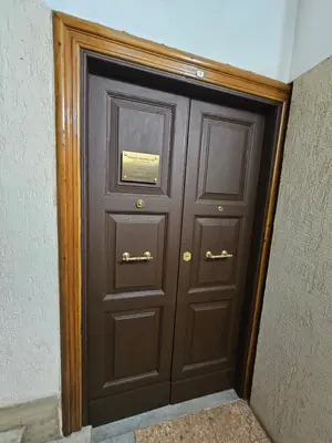 a large wooden door with a plaque on it at Costantino Imperatore Apt in Rome