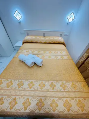 a bedroom with two beds with towels on them at Casa Roma in Rome