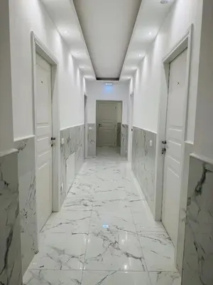a hallway with marble floors and white walls at Casa Roma in Rome