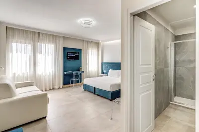 a bedroom with a bed and a couch at Boezio 6 Rooms by Roman Dreams in Rome