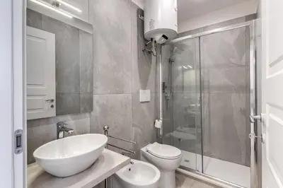 a bathroom with a sink and a toilet and a shower at Boezio 6 Rooms by Roman Dreams in Rome