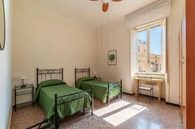 a bedroom with two beds and a window at GuestHost - San Lorenzo Bright Apartment X8 in Rome