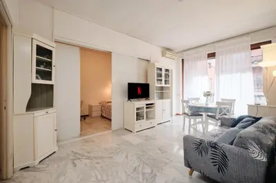 a living room with a couch and a tv at Vaticano - Giubileo - A 2 passi da San Pietro by Hôtea in Rome