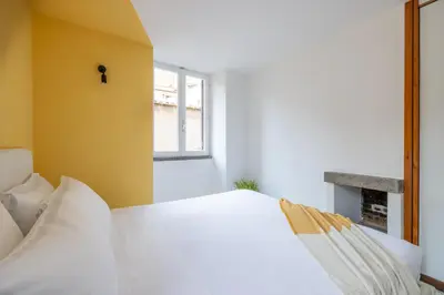 a bedroom with a white bed and a window at Panieri Apt - Homkeey Apartments in Rome