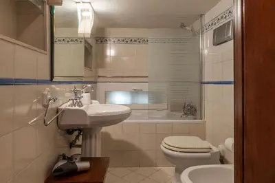 a white bathroom with a sink and a toilet at GuestHost - Apartment Near Piazza Navona in Rome