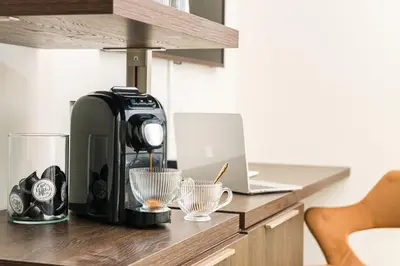 a coffee maker sitting on a counter with a laptop at IV Leoni in Rome