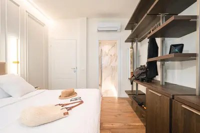 a bedroom with a white bed with a wooden counter at IV Leoni in Rome
