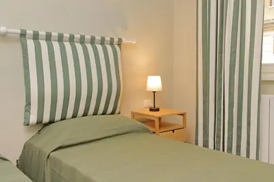 a bedroom with a bed and a lamp on a table at Gioia's Flat in Rome