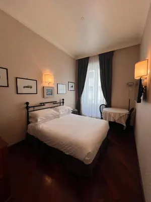 a hotel room with a bed and a window at Residenza Lucullo in Rome
