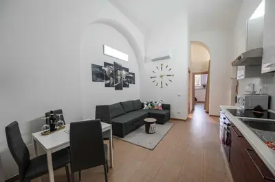 a kitchen and living room with a couch and a clock at Betterplace 2 in Rome
