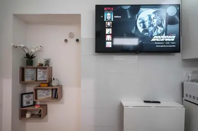 a television on the wall of a kitchen with at Betterplace 2 in Rome