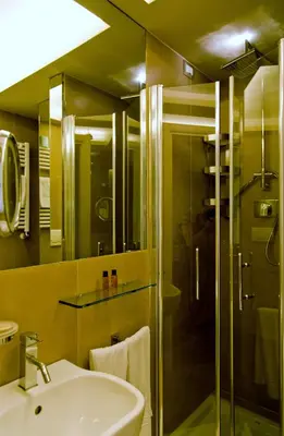 a bathroom with a glass shower and a sink at Hotel Valeri in Rome