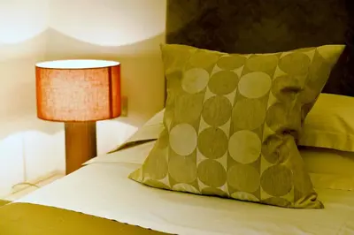 a bed with a yellow pillow and a lamp at Hotel Valeri in Rome