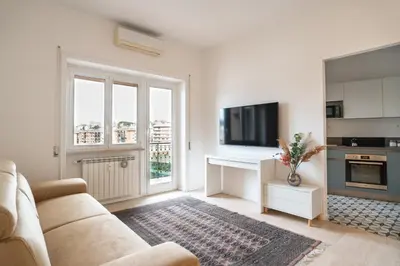 a white living room with a couch and a tv at Casa Vista San Pietro in Rome