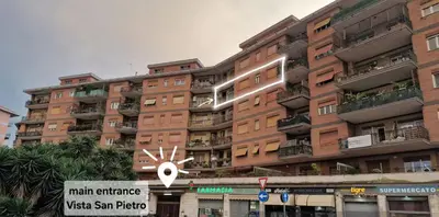a large apartment building with a sign in front of it at Casa Vista San Pietro in Rome