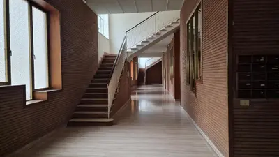 an empty hallway of a brick building with stairs at Casa Vista San Pietro in Rome