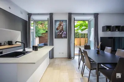 a kitchen and dining room with a black table and chairs at Luxury House in Roma Nicolo V 120 mq in Rome