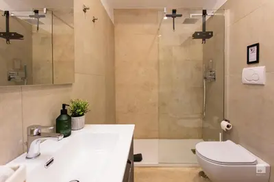 a bathroom with a sink and a toilet and a shower at Luxury House in Roma Nicolo V 120 mq in Rome