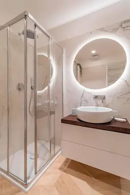 a bathroom with a sink and a mirror at AureaLiving - Sage luxury apt with Air Conditioning, Fast Wifi and free Gym in Rome