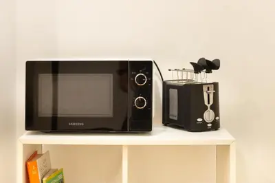 a microwave and a toaster oven on a shelf at NOH Vatican Courtyard in Rome