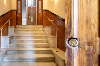 a set of stairs in a building with a door at NOH Vatican Courtyard in Rome