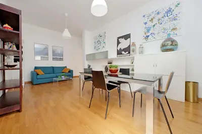 a dining room and living room with a table and chairs at YCH-Nice flat with patio near Vatican in Rome