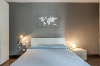 a bedroom with a large bed with a map on the wall at Primavera Home in Rome