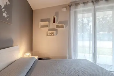 a bedroom with a bed and a large window at Primavera Home in Rome